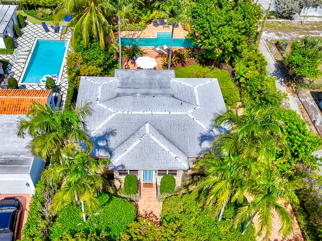 an aerial view of a house with a yard basket ball court and outdoor seating