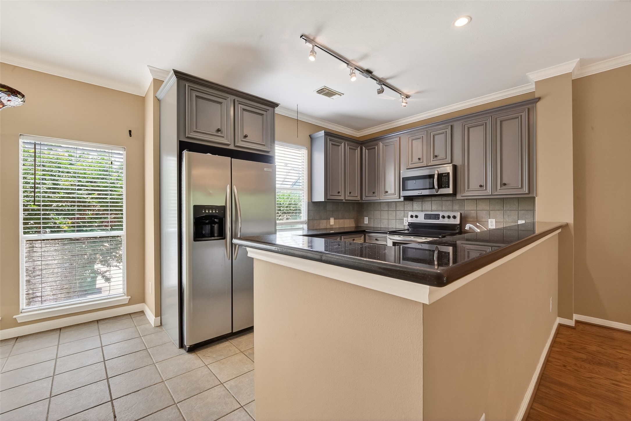 2804 Chenevert Street Houston, TX 77004 - Photo 17 of 37 a kitchen with stainless steel appliances granite countertop a refrigerator a stove a sink a microwave and cabinets