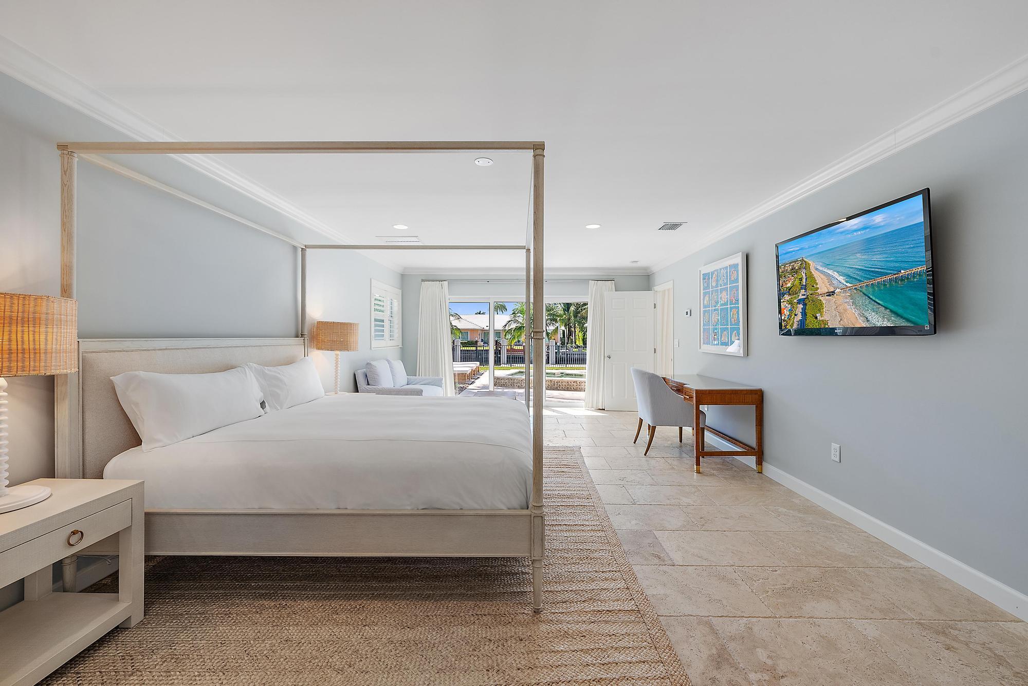 1051 Gulfstream Way Singer Island, FL 33404 - Photo 15 of 49 a bedroom with a bed a table and painting