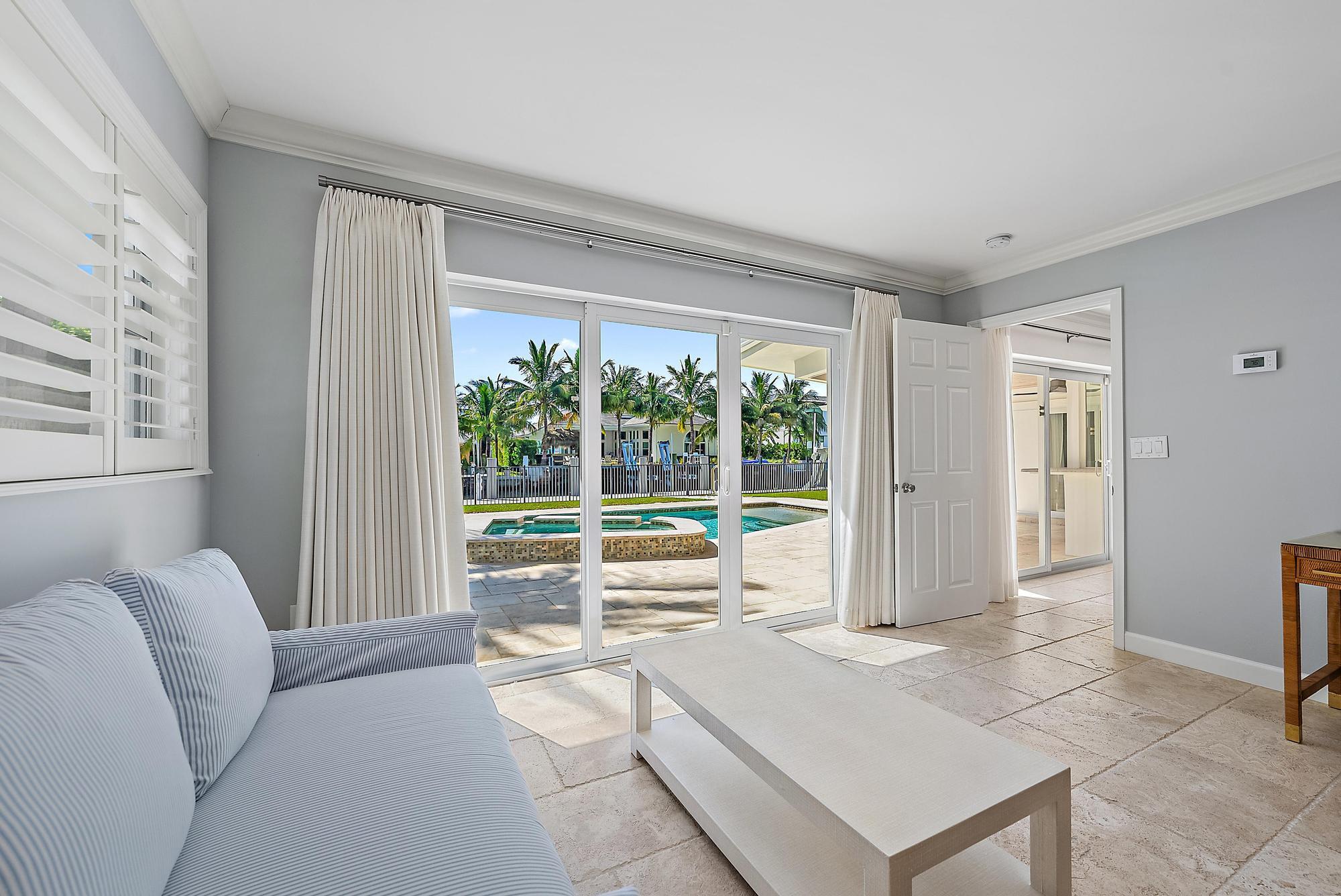1051 Gulfstream Way Singer Island, FL 33404 - Photo 19 of 49 a living room with furniture and large windows