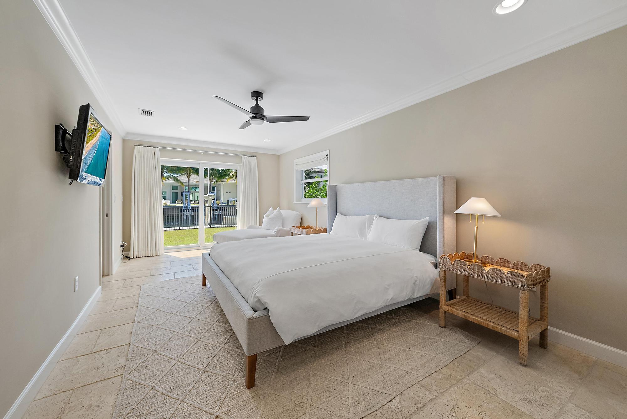 1051 Gulfstream Way Singer Island, FL 33404 - Photo 29 of 49 a spacious bedroom with a bed and a window