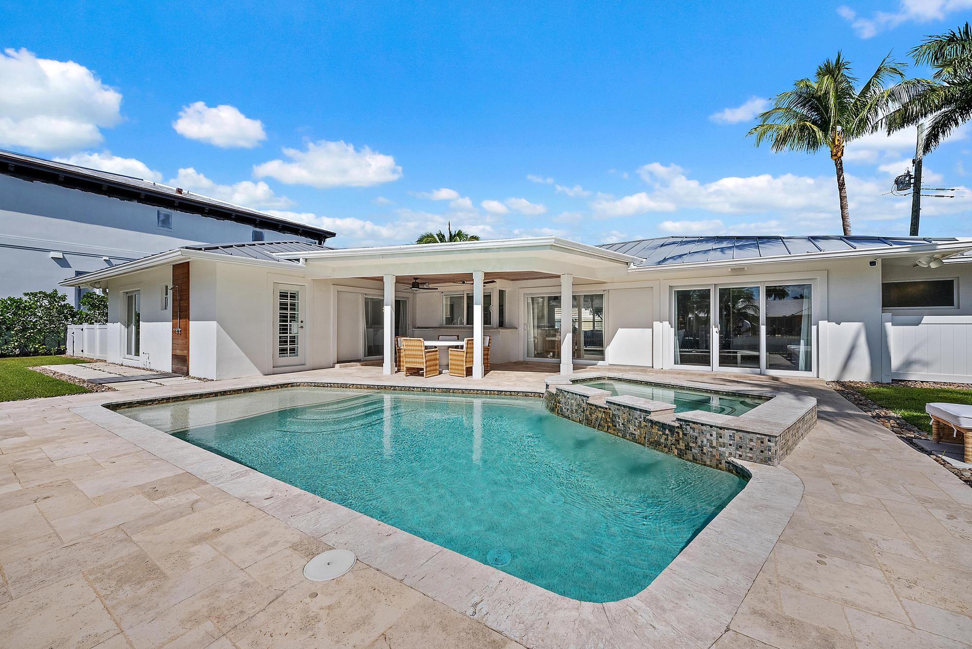 1051 Gulfstream Way Singer Island, FL 33404 - Photo 31 of 49 front view of a house with a swimming pool