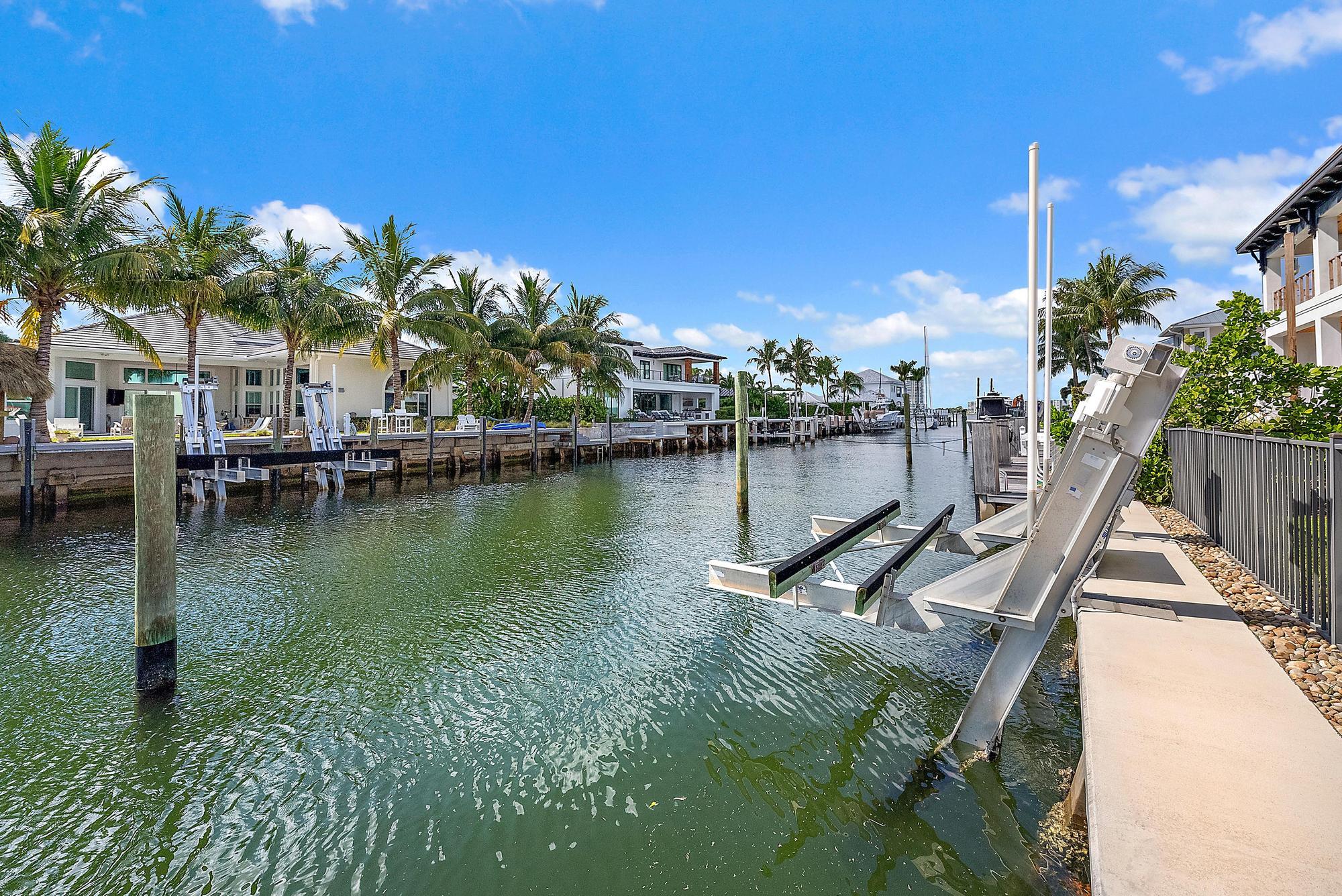 1051 Gulfstream Way Singer Island, FL 33404 - Photo 35 of 49 a view of a lake with a house