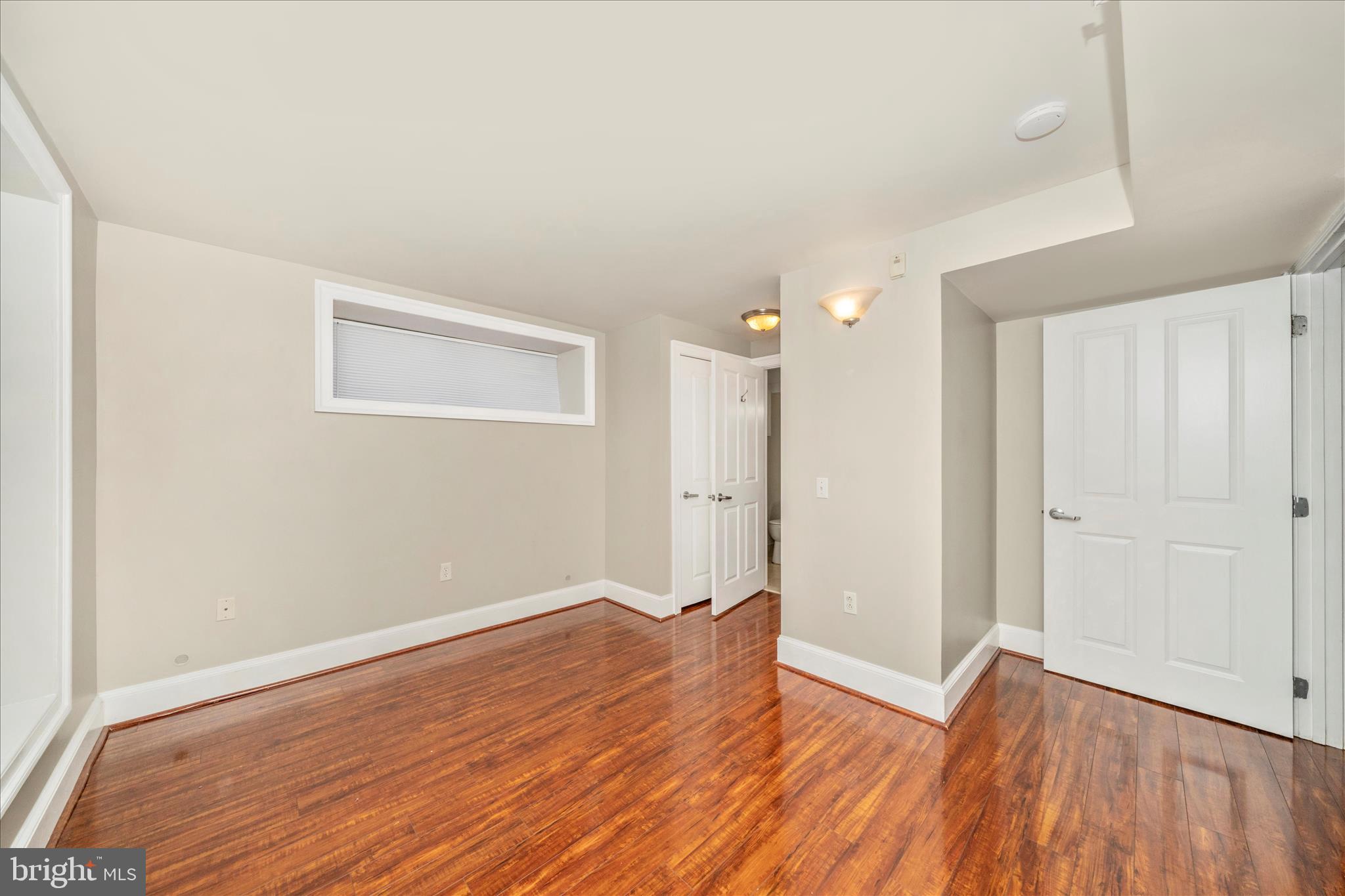 1750 16th Street Northwest, Unit 4 Washington, DC 20009 - Photo 19 of 53 a view of a room with wooden floor and white doors