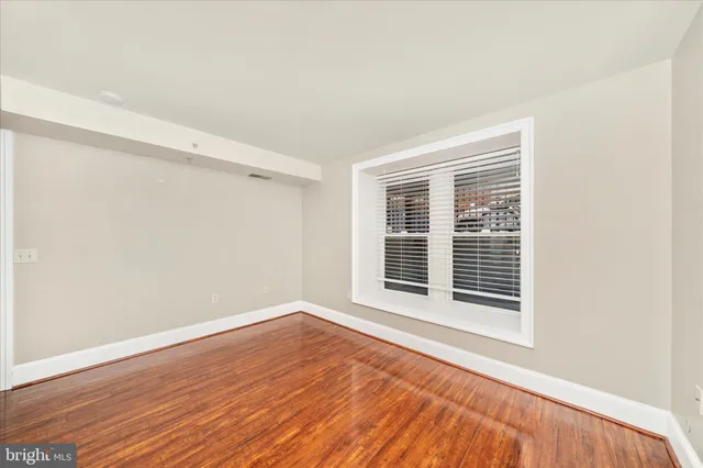 a view of a room with wooden floor and windows