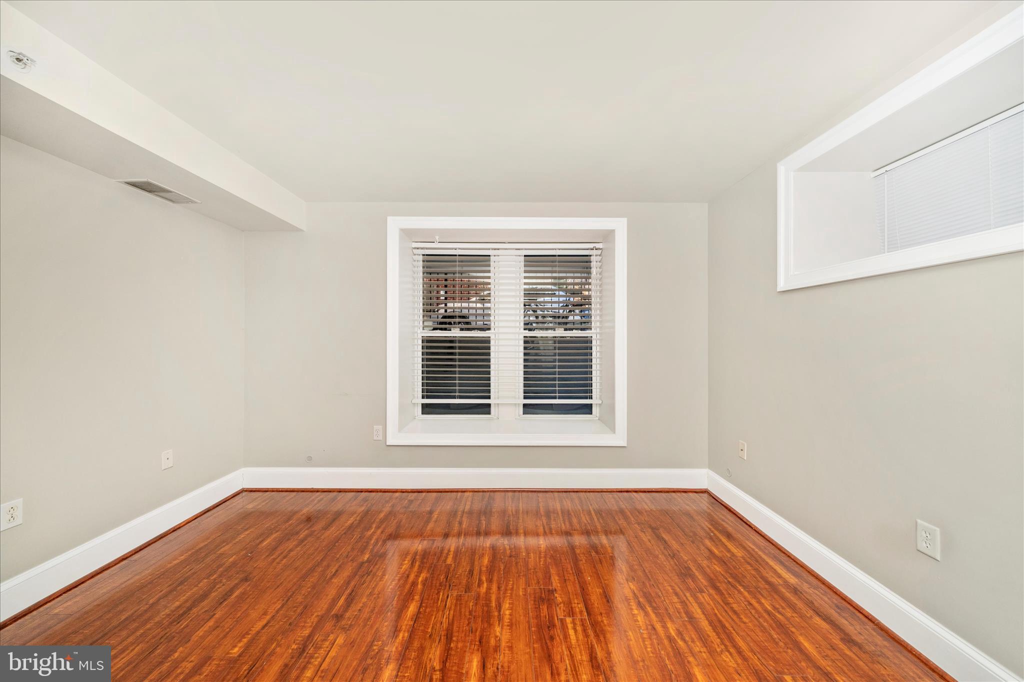 1750 16th Street Northwest, Unit 4 Washington, DC 20009 - Photo 22 of 53 a view of an empty room with wooden floor and a window