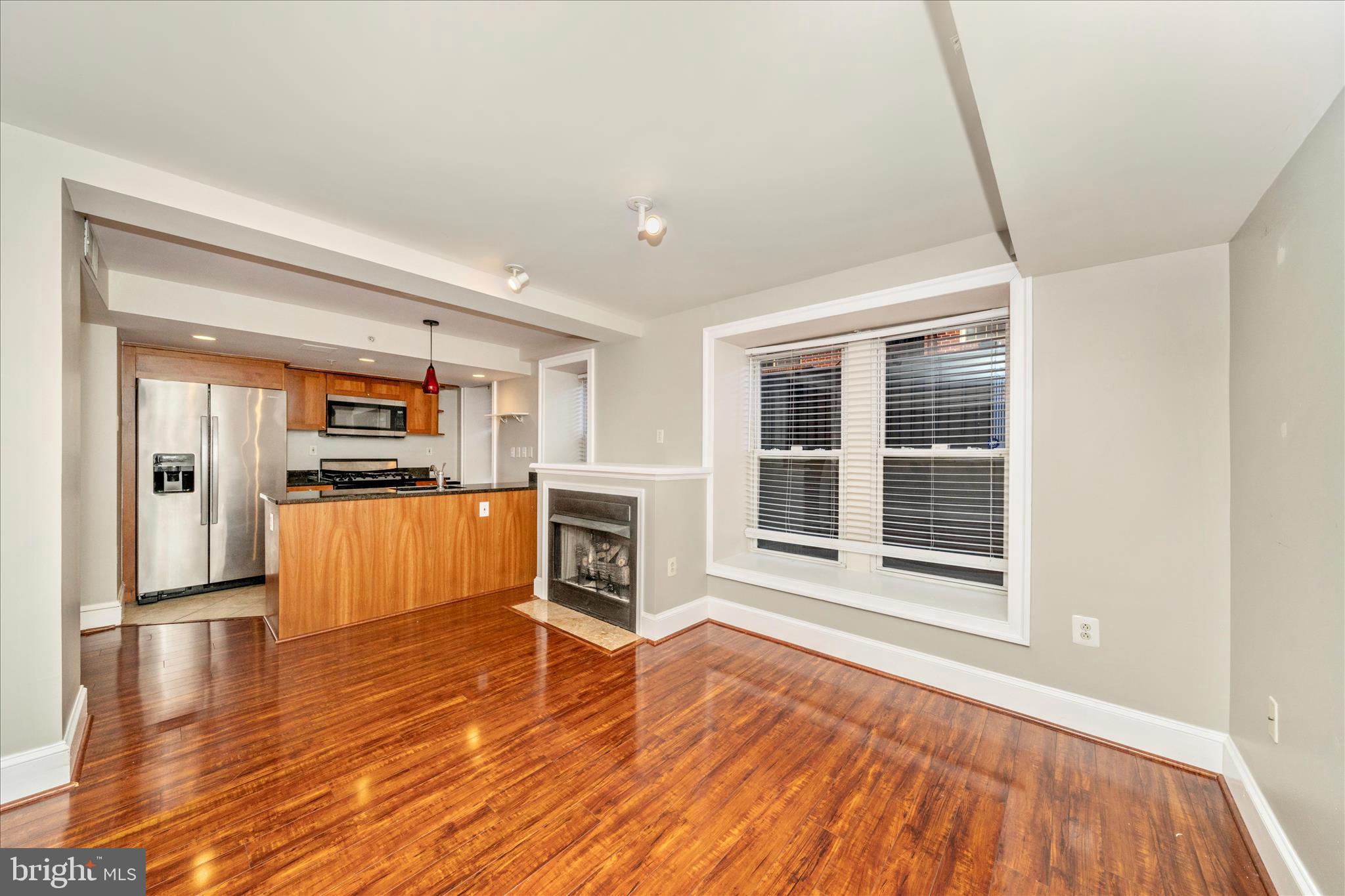 1750 16th Street Northwest, Unit 4 Washington, DC 20009 - Photo 26 of 53 a view of empty room with wooden floor and kitchen view