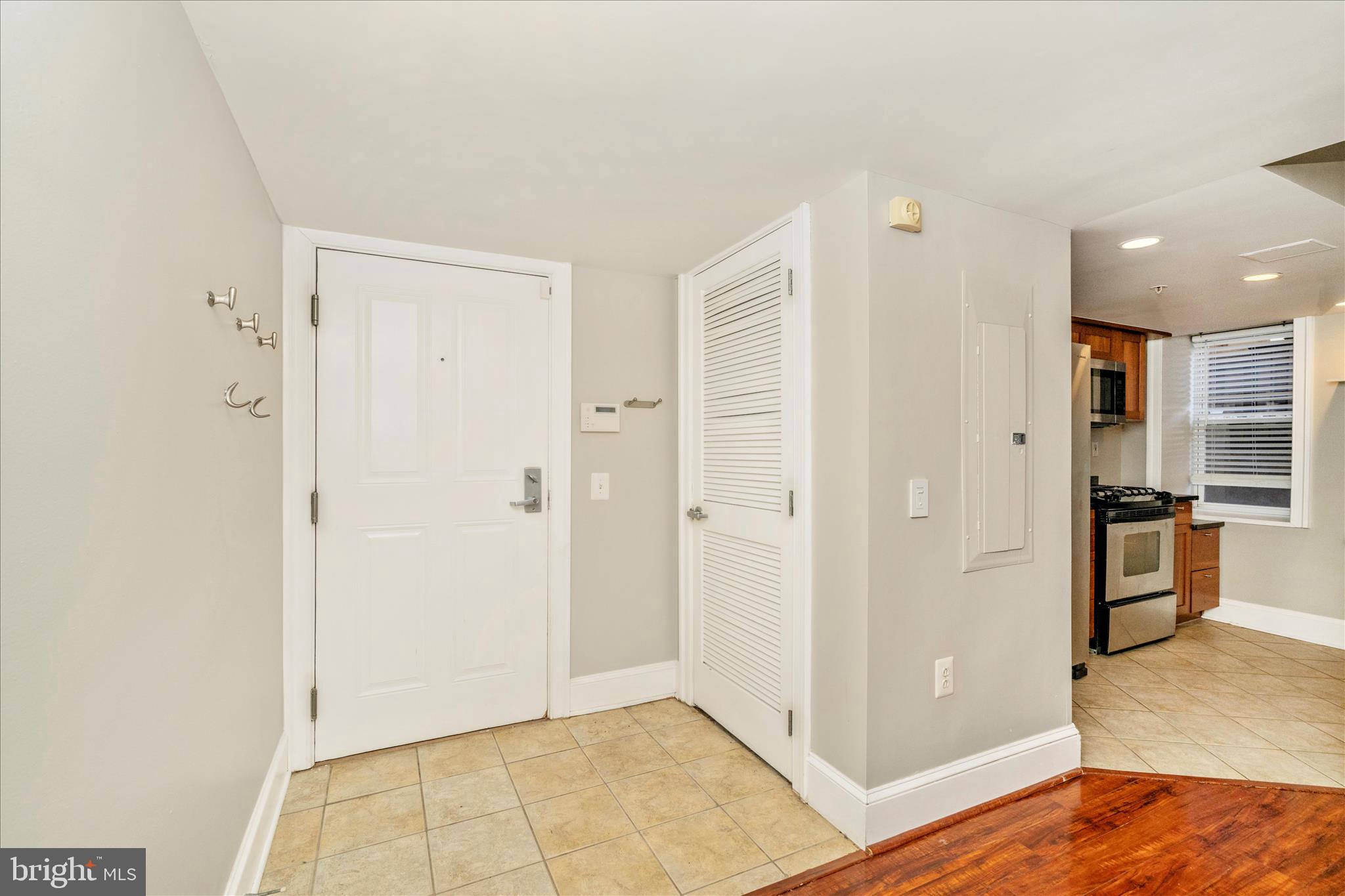 1750 16th Street Northwest, Unit 4 Washington, DC 20009 - Photo 3 of 53 a view of a kitchen with refrigerator and wooden floor