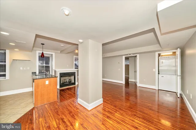 a view of a kitchen with a refrigerator and a stove top oven