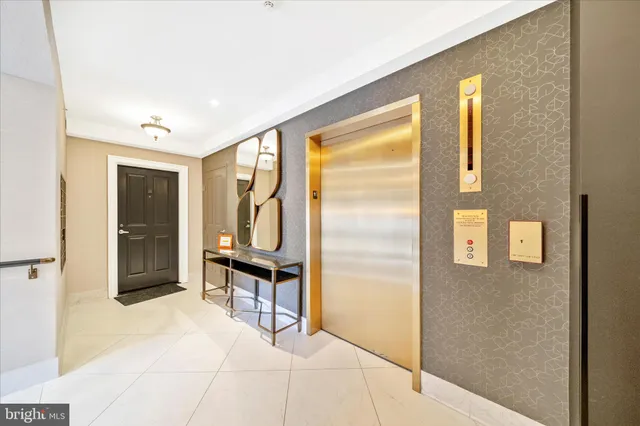 a view of a hallway with wooden floor table and windows