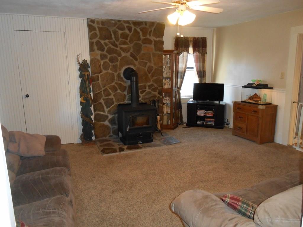 587 Amity Ridge Road Amity, PA 15311 - Photo 2 of 25 Living room with wood burning stove to supplement your heating bill.