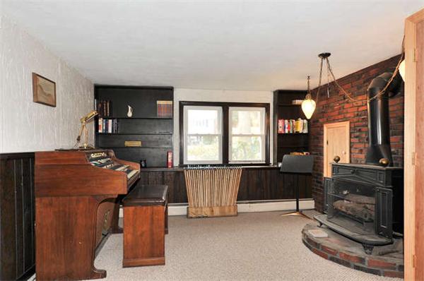 13 Town Line Road Burlington, MA 01803 - Photo 15 of 22 a living room with furniture a piano and a flat screen tv