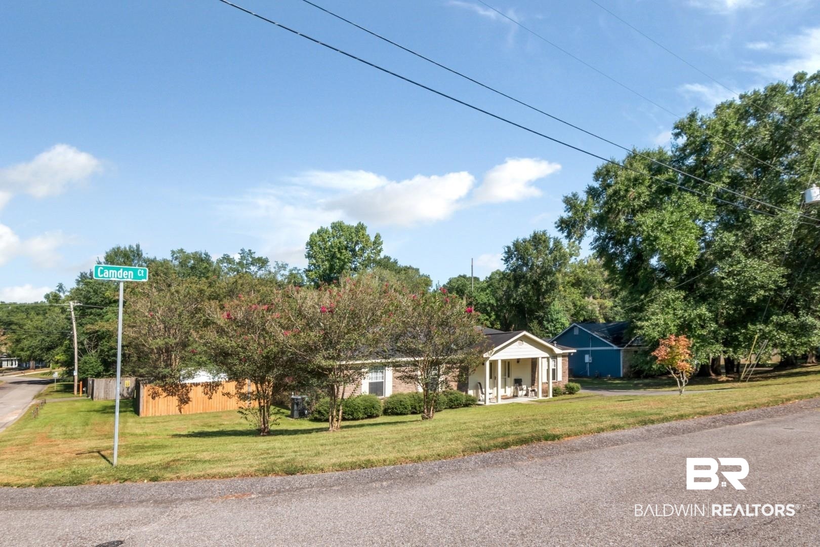 1345 Camden Court Mobile, AL 36695 - Photo 31 of 31 View of front of property featuring a front lawn, a porch, and view of scattered trees