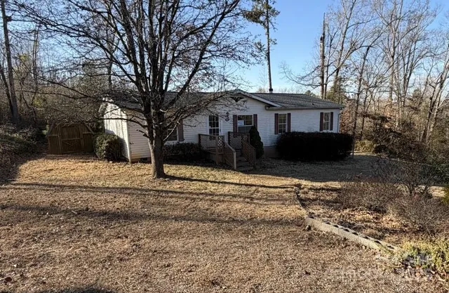 a view of a house with a yard covered with snow in front of house