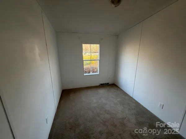 a view of an empty room and staircase