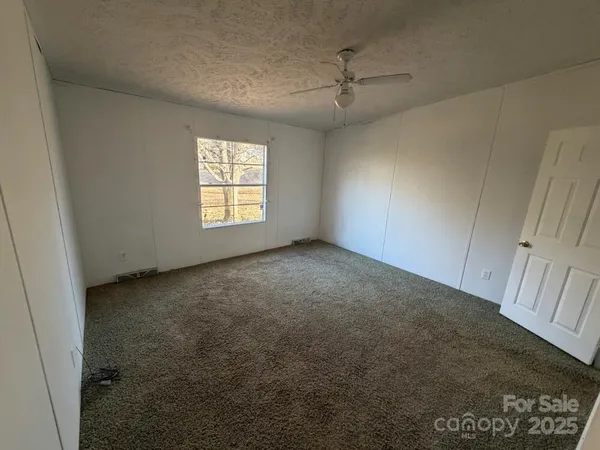 an empty room with windows and entrance