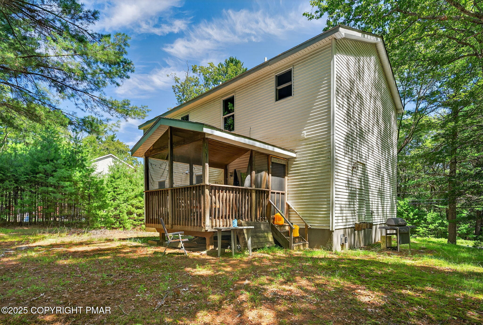 375 Marcel Drive Dingmans Ferry, PA 18328 - Photo 15 of 25 a backyard of a house with table and chairs