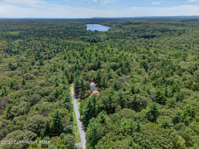 an aerial view of a houses with a yard