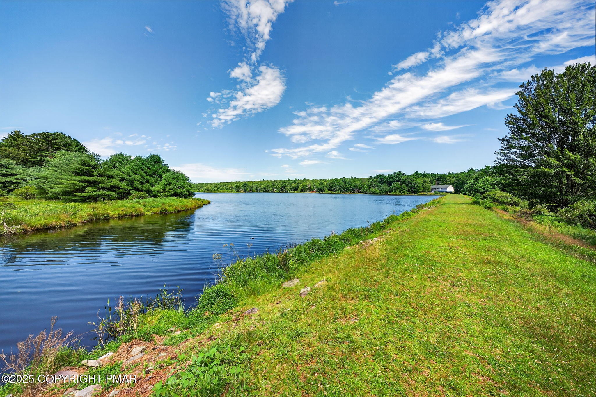 375 Marcel Drive Dingmans Ferry, PA 18328 - Photo 21 of 25 a view of a lake with a big yard