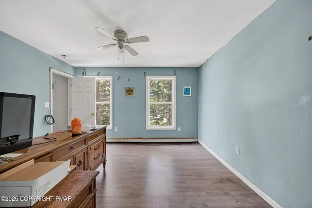 a view of room with window and wooden floor
