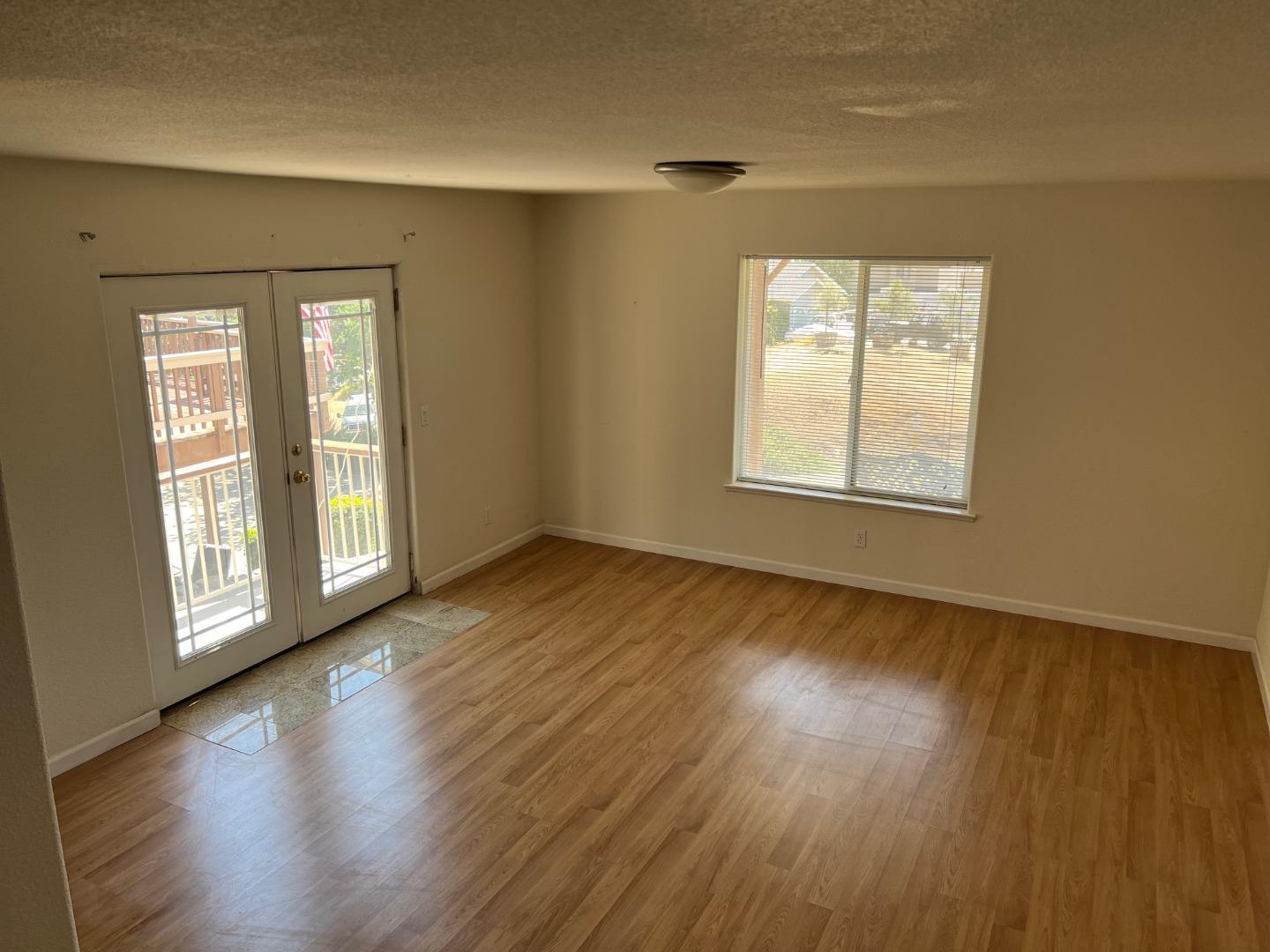 629 Poker Flat Road Copperopolis, CA 95228 - Photo 13 of 18 a view of an empty room with wooden floor and a window