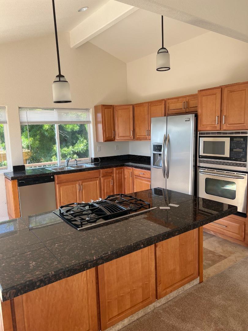 629 Poker Flat Road Copperopolis, CA 95228 - Photo 5 of 18 a kitchen with granite countertop a sink and a stove