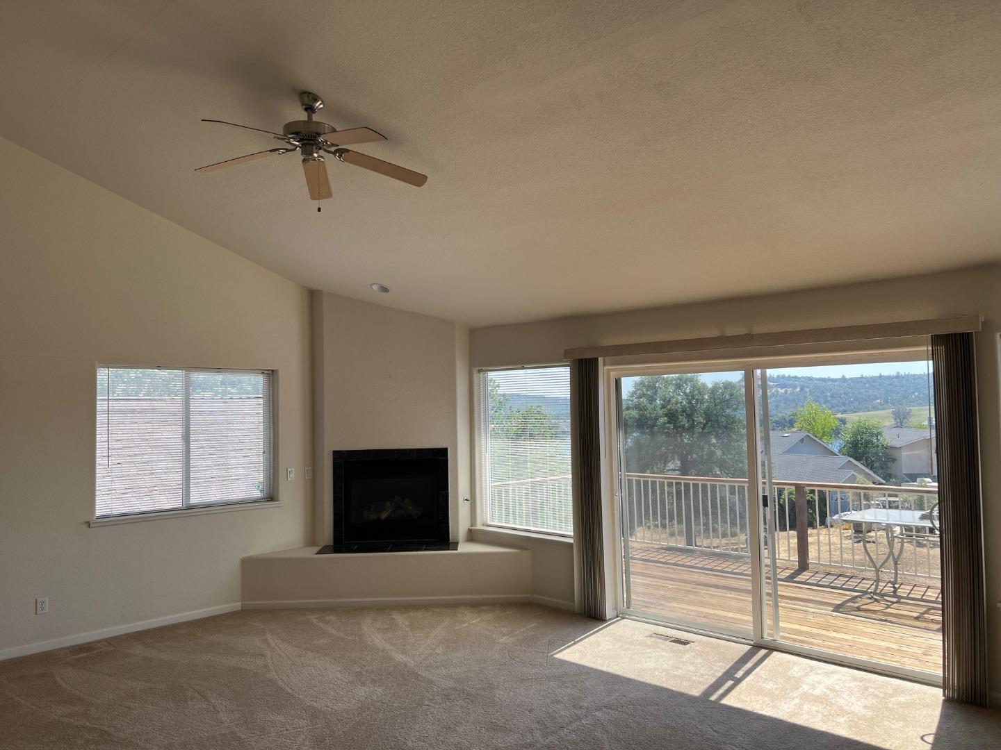 629 Poker Flat Road Copperopolis, CA 95228 - Photo 8 of 18 a living room with a fireplace and a flat screen tv