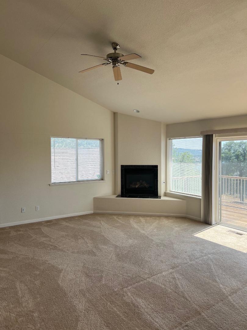 629 Poker Flat Road Copperopolis, CA 95228 - Photo 9 of 18 an empty room with windows and fireplace