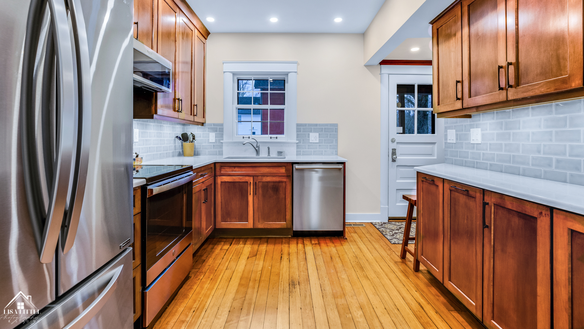 32W186 Army Trail Road Wayne, IL 60184 - Photo 8 of 27 a kitchen with stainless steel appliances granite countertop a refrigerator a sink dishwasher a stove and white countertops with wooden floor