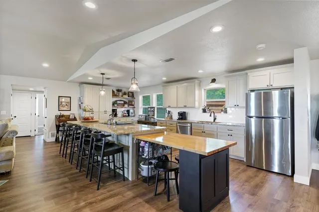 a kitchen with lots of counter top space and stainless steel appliances