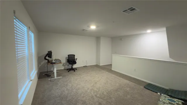 a bed sitting in a bedroom next to a window