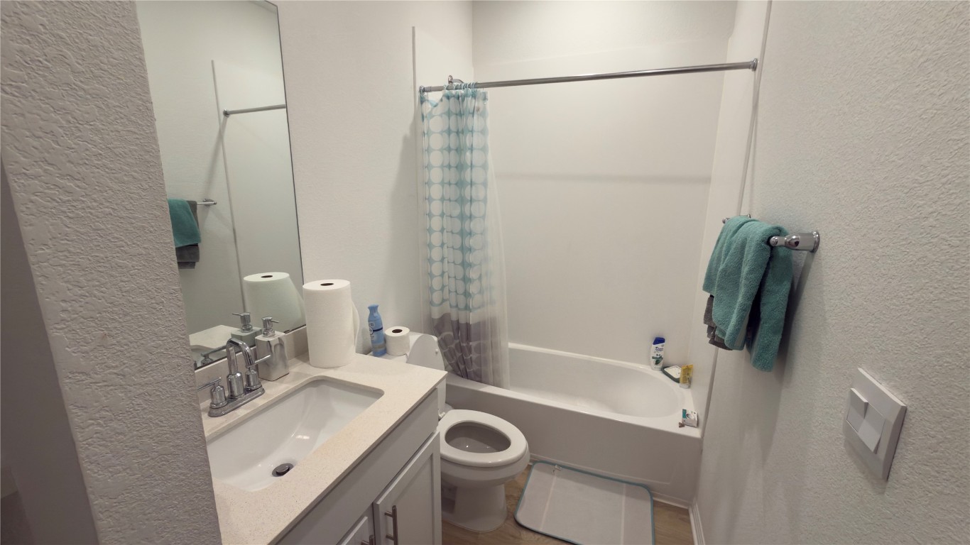 2512 Hackamore Drive Leander, TX 78641 - Photo 16 of 35 a bathroom with a sink a toilet and shower