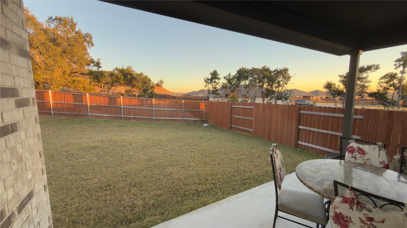 2512 Hackamore Drive Leander, TX 78641 - Photo 18 of 35 a backyard of a house with table and chairs
