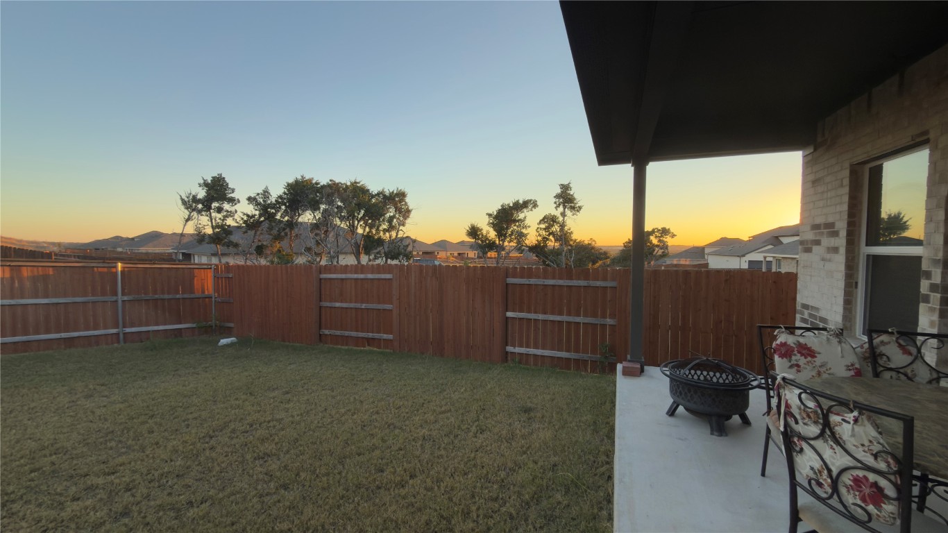 2512 Hackamore Drive Leander, TX 78641 - Photo 19 of 35 a backyard of a house with barbeque oven and furniture