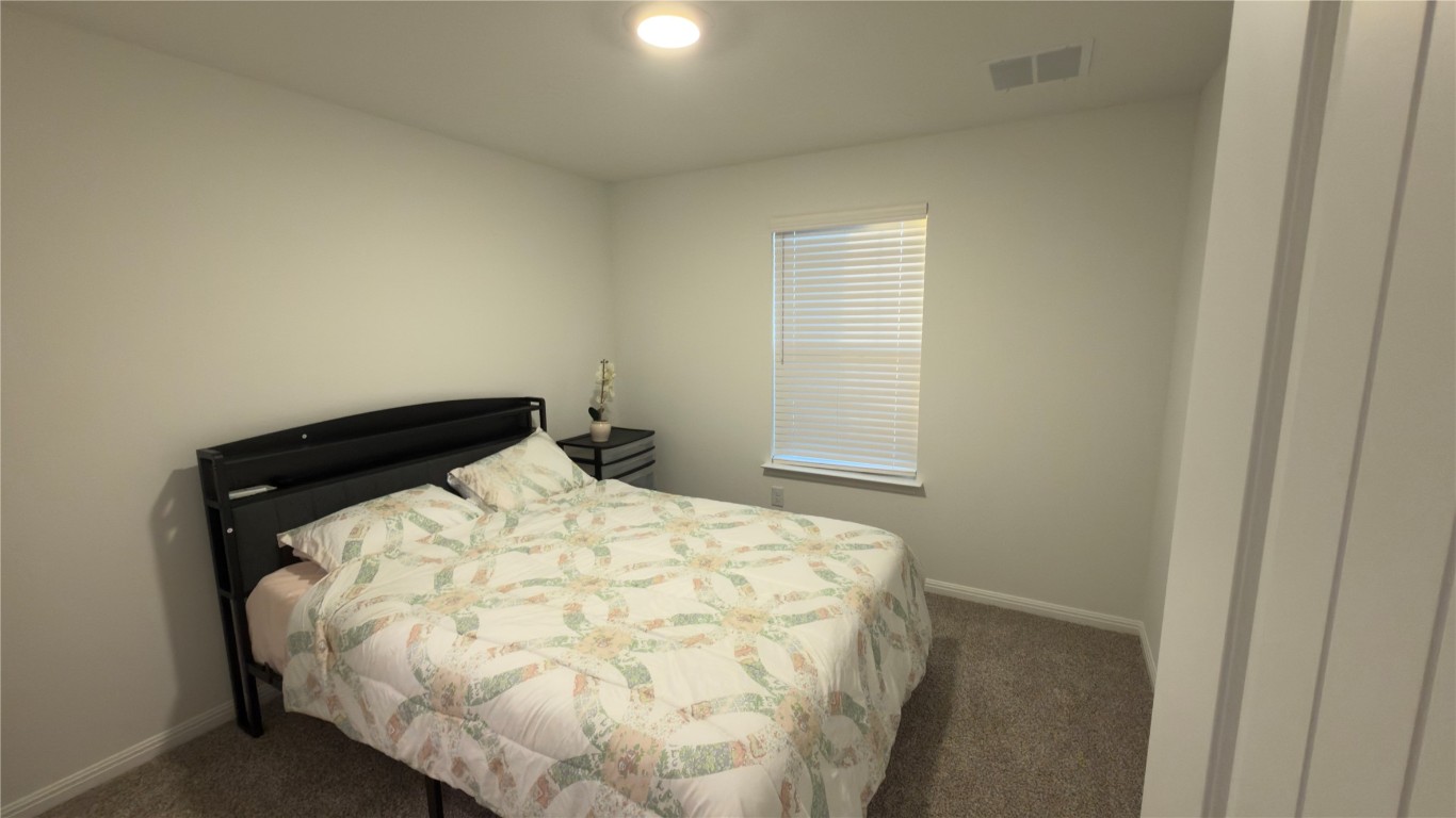 2512 Hackamore Drive Leander, TX 78641 - Photo 30 of 35 a bed sitting in a bedroom next to a window