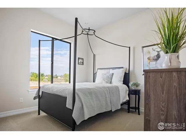 a bedroom with a bed window and a potted plant