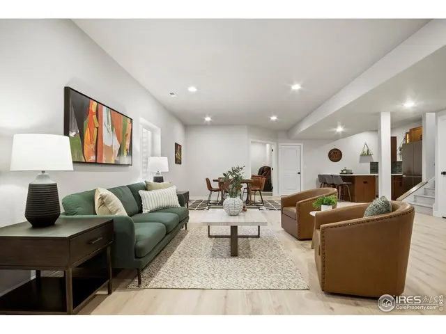 a living room with furniture a rug and a painting