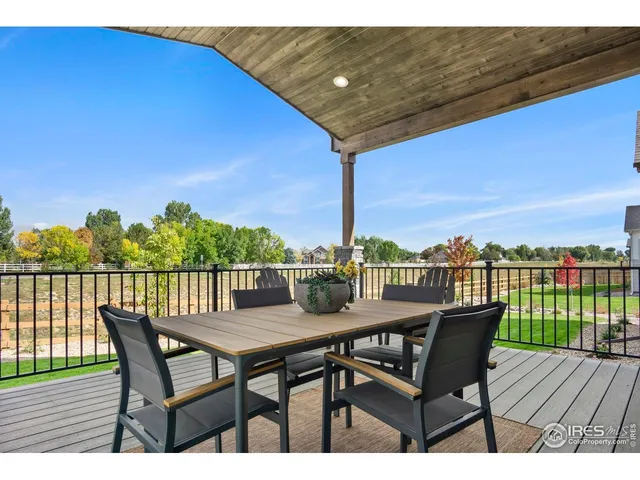 a view of a balcony with furniture and wooden floor