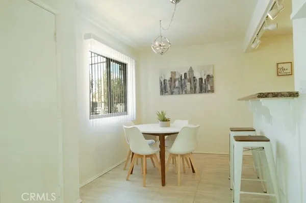 a view of a dining room with furniture and a window