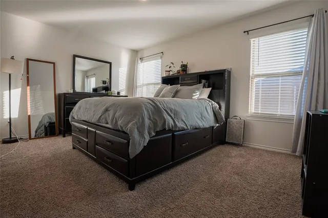 a spacious bedroom with a bed and a window
