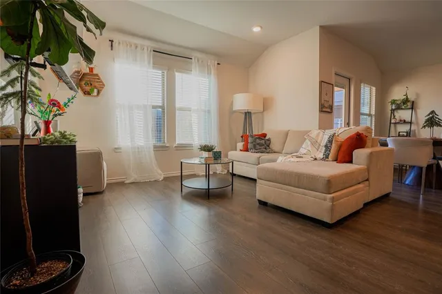 a living room with furniture and a potted plant