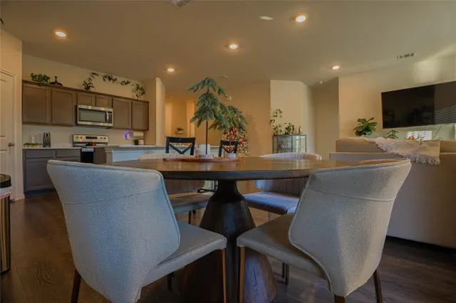 a view of a dining room with furniture and wooden floor