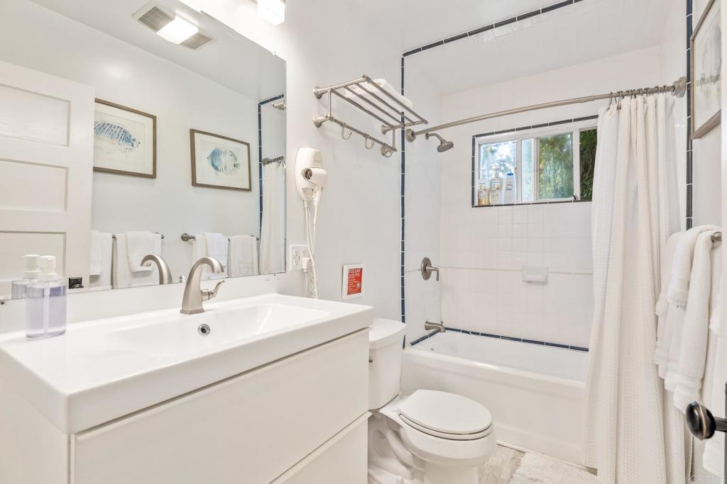 2432 3rd Street Santa Monica, CA 90405 - Photo 20 of 62 a bathroom with a sink a toilet a mirror a vanity and shower