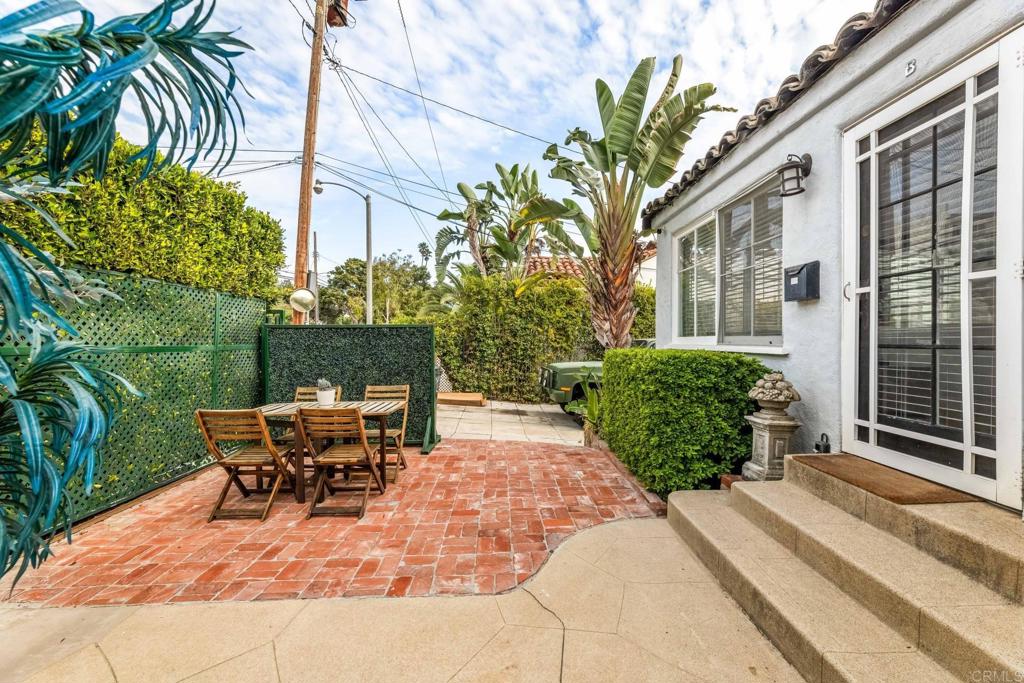 2432 3rd Street Santa Monica, CA 90405 - Photo 32 of 62 a view of a patio with table and chairs potted plants and floor to ceiling window