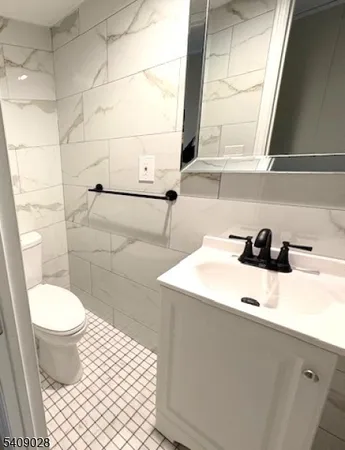 a bathroom with a sink toilet and a mirror