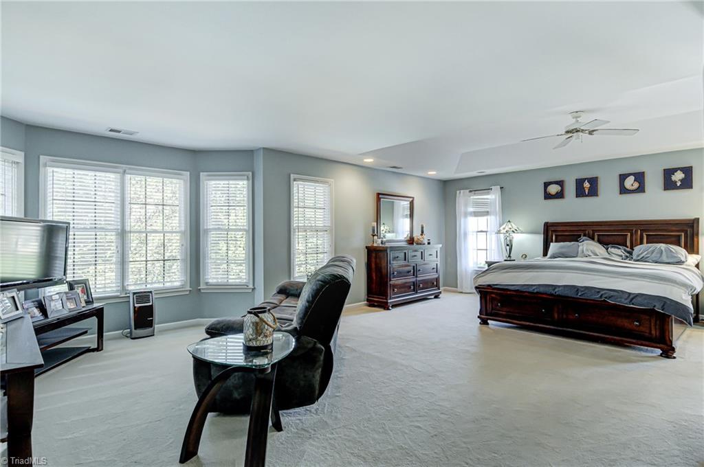 5401 Leytonstone Court Oak Ridge, NC 27310 - Photo 18 of 41 Owners Suite is bright and spacious and has sitting area with bay window.