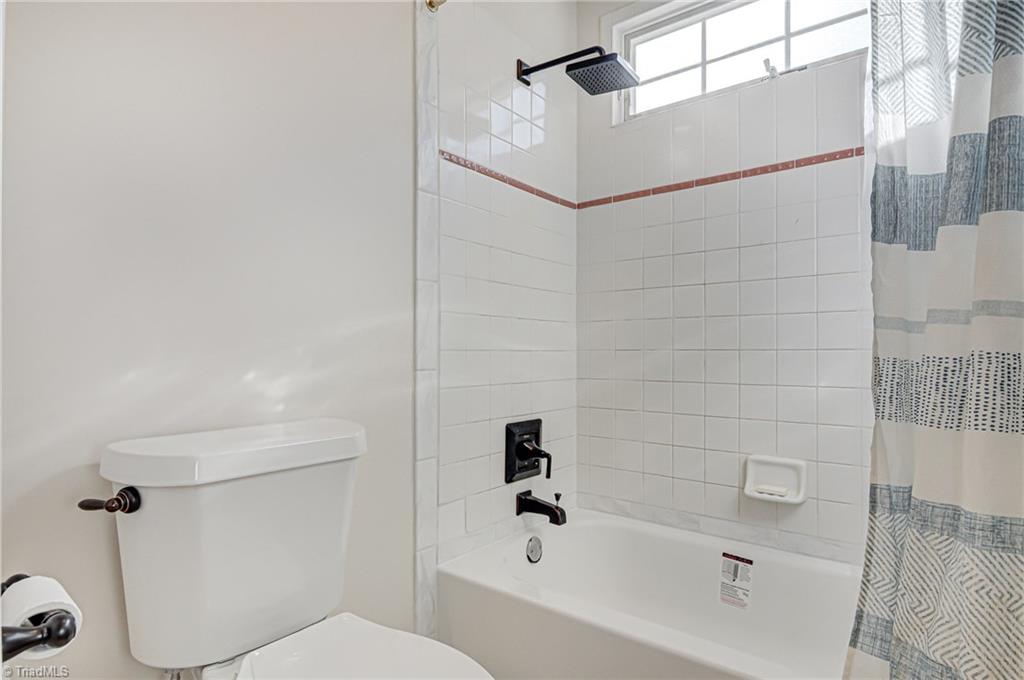 5401 Leytonstone Court Oak Ridge, NC 27310 - Photo 30 of 41 Jack N Jill bath with new toilet and tub. Transom window adds natural lighting.