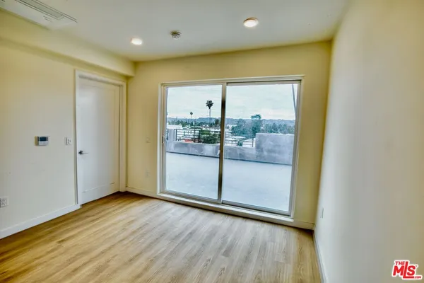 a view of hallway with wooden floor