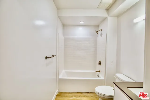 a bathroom with a bathtub and a toilet