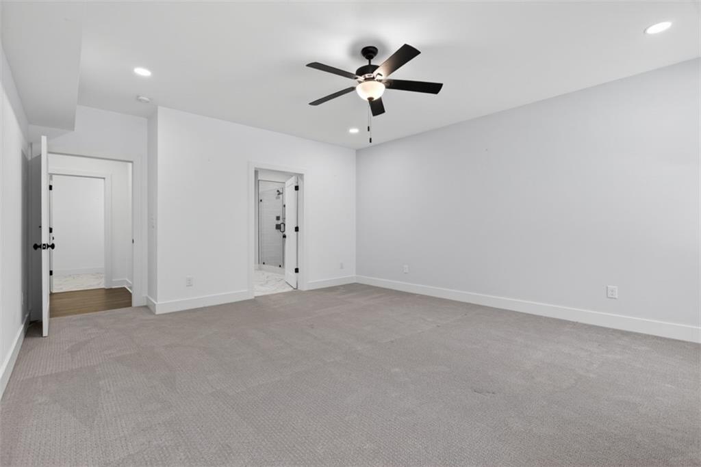 3528 North Bogan Road Buford, GA 30519 - Photo 68 of 79 an empty room with a ceiling fan and a window